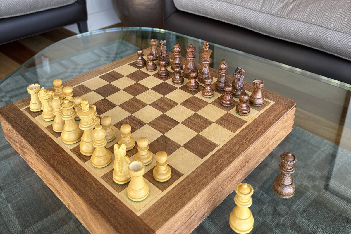 Wooden chess set on a wooden chessboard on a living room coffee table